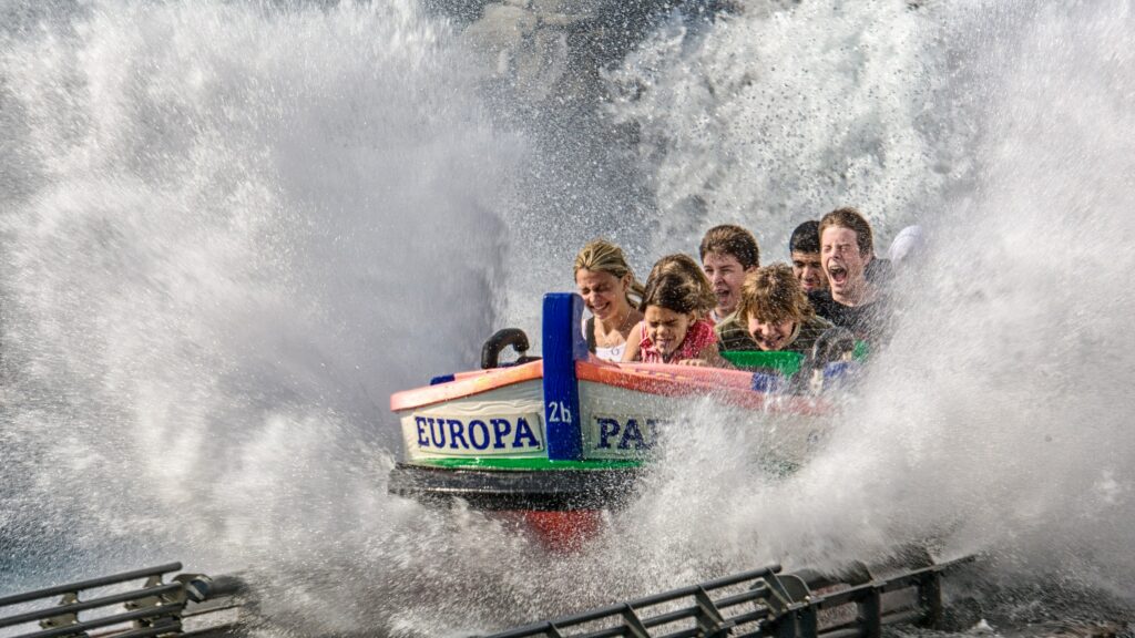 children on a ride through water in a theme park